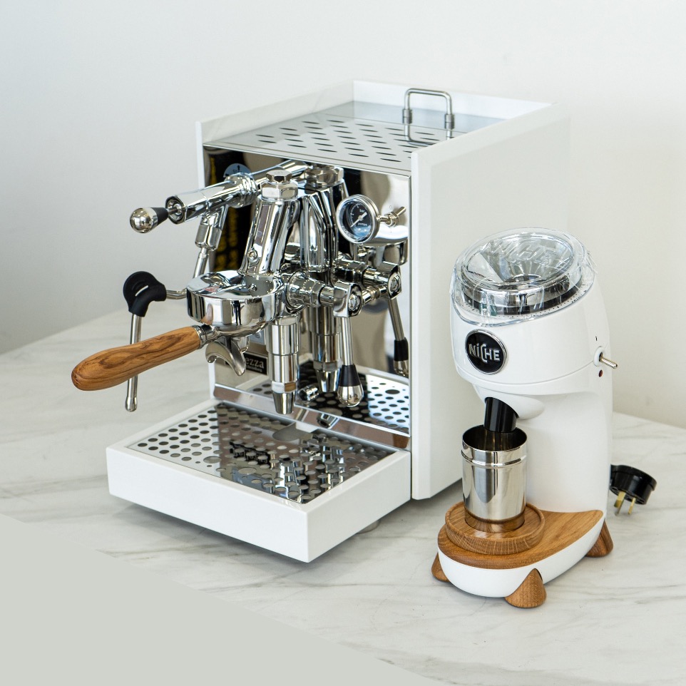 a coffee machine sitting on top of a white counter
